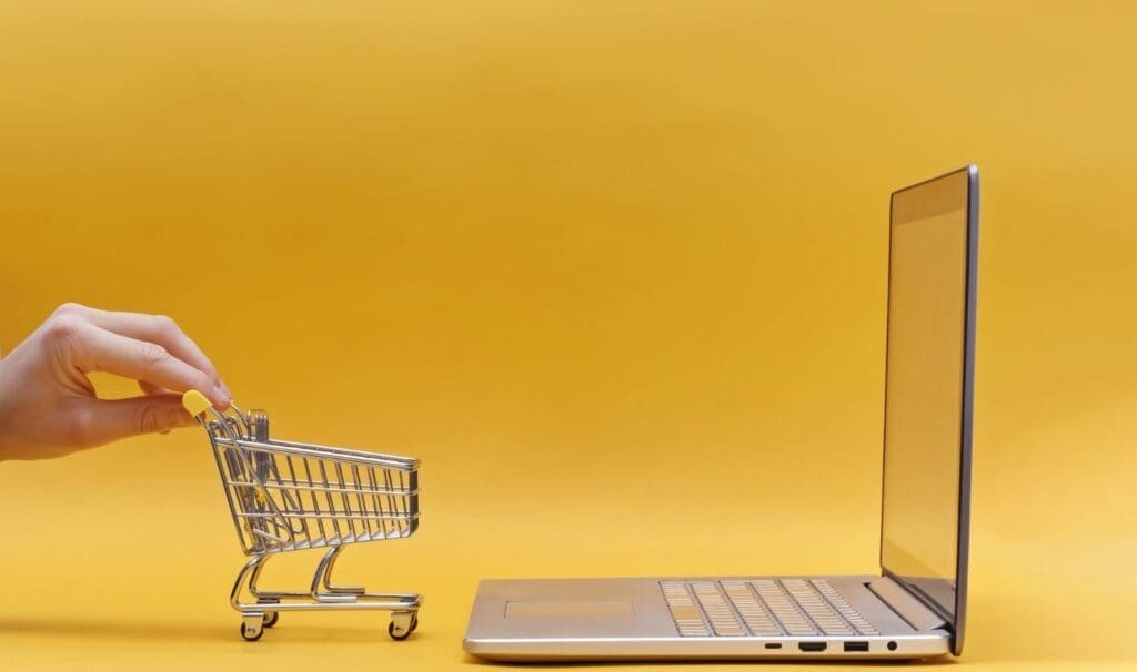 a small grocery cart in front of a laptop