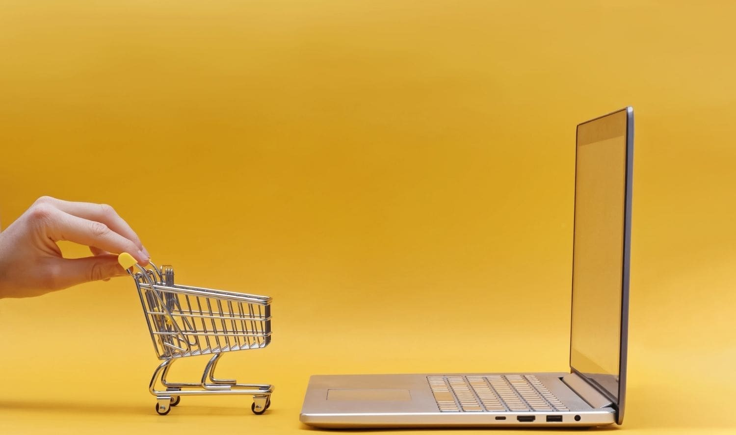 a small grocery cart in front of a laptop